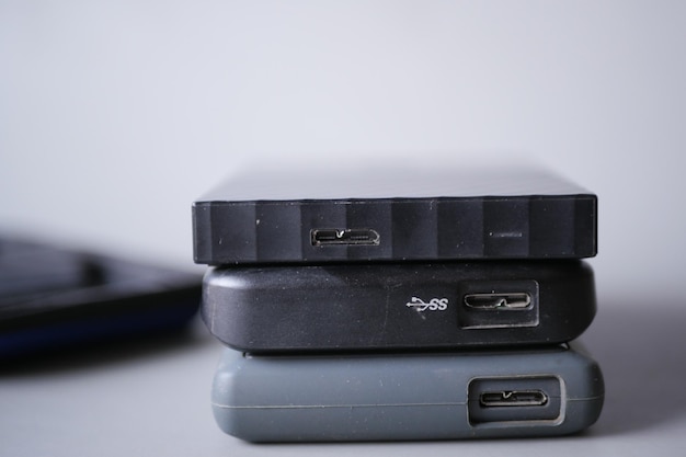 Stack of external hard drives on table