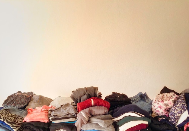 Stack of folded clothes against wall