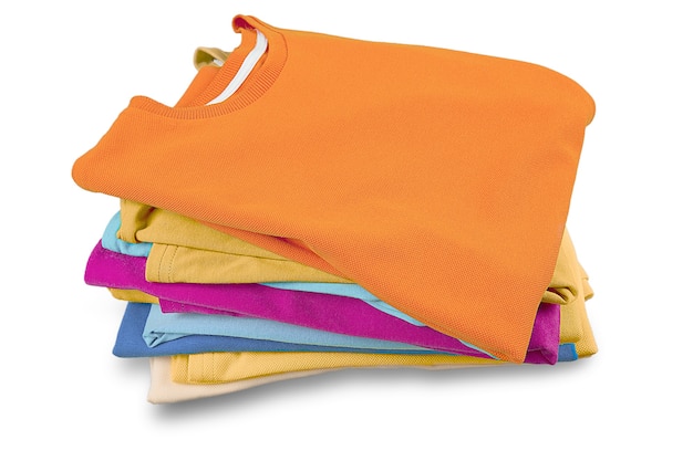 Stack of folded garments. Closeup over white background.