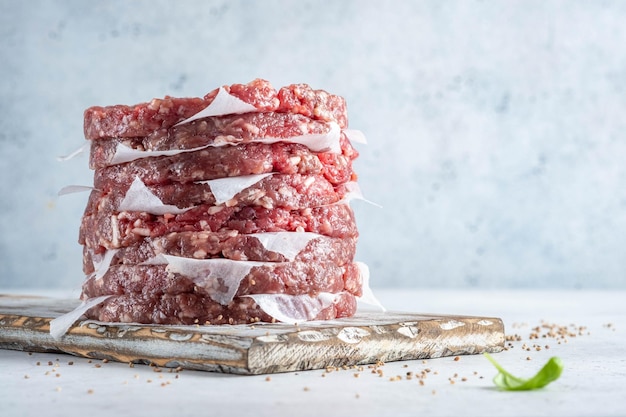 Stack of fresh raw beef burger patty