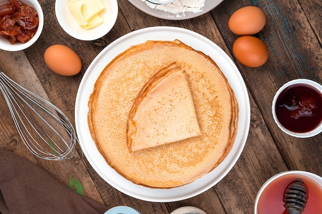 A stack of fried pancakes and ingredients.