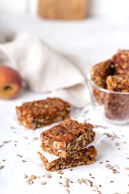 Stack of fruit and nut bars, useful components, for healthy concept. Light background