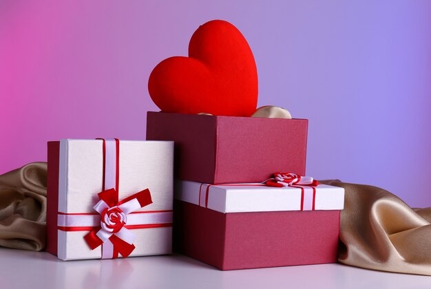 Stack of gift boxes and decorative heart,