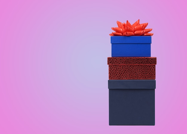 Stack of gift boxes on pink surface