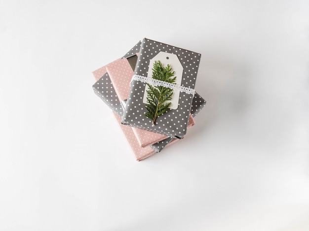 Stack of gifts in pink and gray polka dot paper 