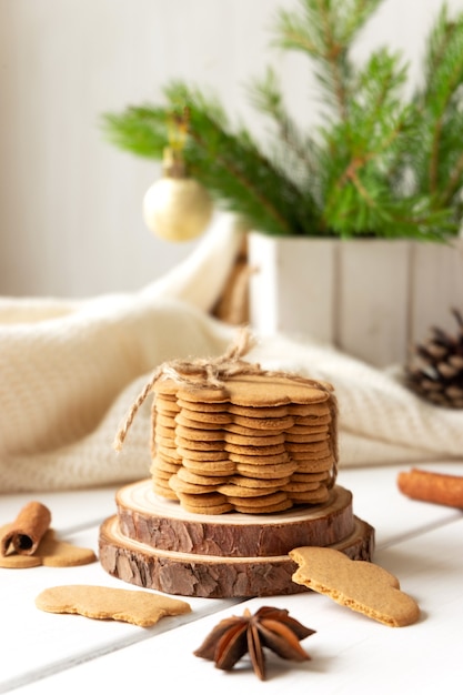 Stack of ginger cookies and spices on wooden tabletop