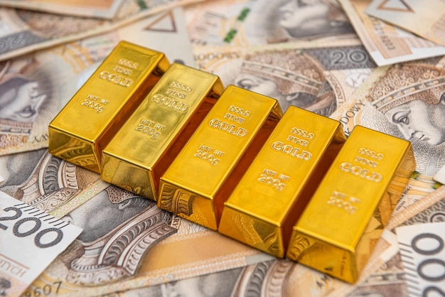 Stack of gold bars of zloty bills