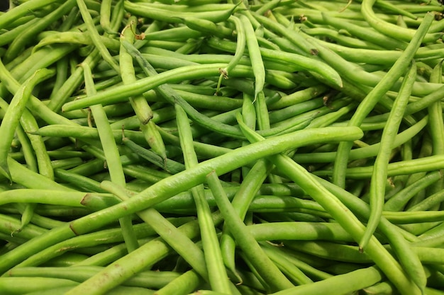 Stack of green beans on a market stall