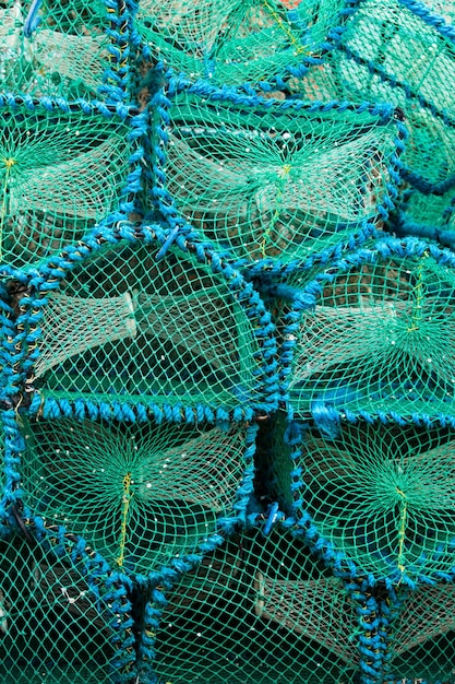 A stack of green fishing nets with blue bands