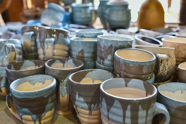 a stack of handmade painting ceramic cups