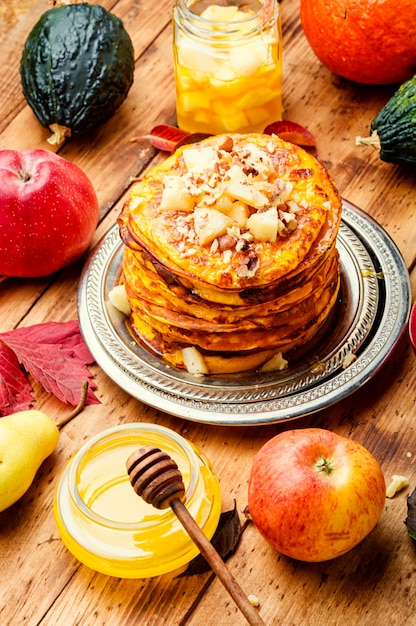 Stack of homemade pumpkin pancakes.Pumpkin pancakes with honey