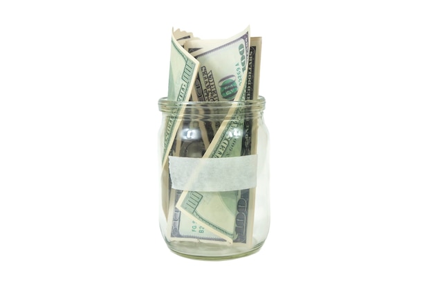 A stack of hundred-dollar bills in a jar with an empty label for the inscription