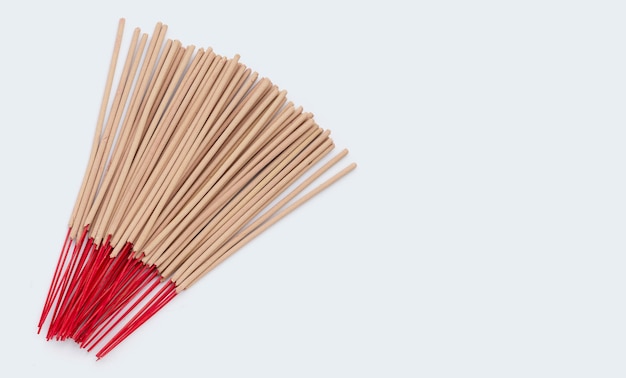 Stack of incense sticks on white background.