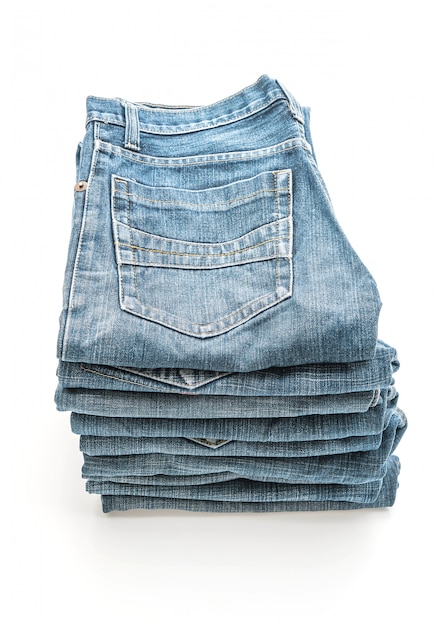 stack of jeans folded on white background