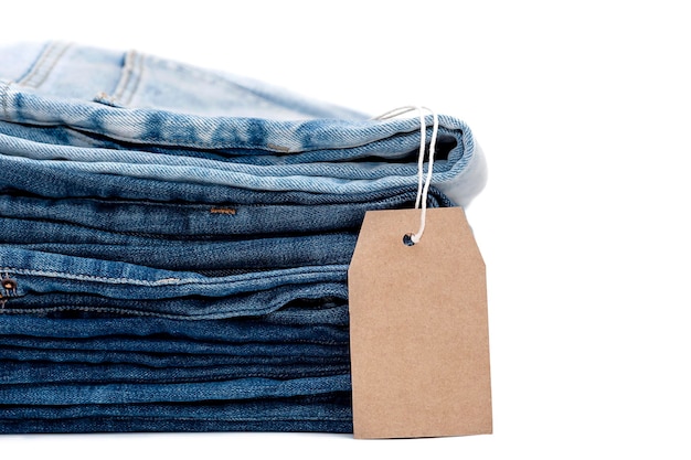Stack of jeans with label isolated on white background close up