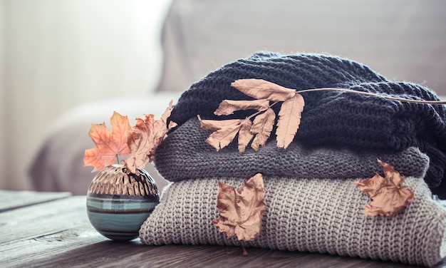 Photo stack of knitted sweaters on a wooden table