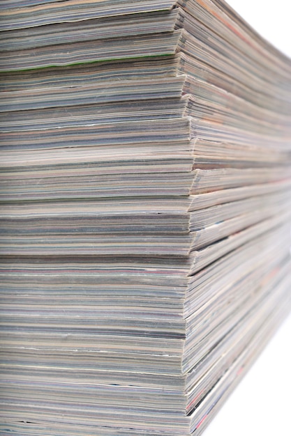 Stack of magazines and newspapers on a white background.