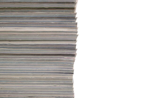 Stack of magazines and newspapers on a white background.