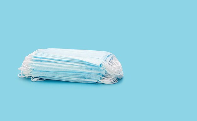 a stack of medical masks on a blue background