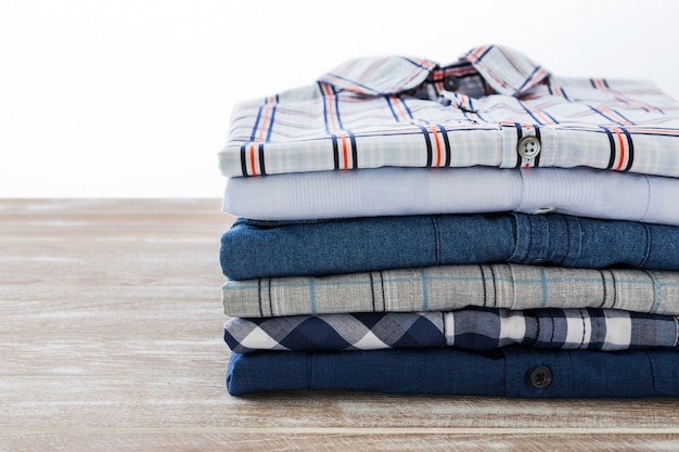 Stack of men shirts on wooden table