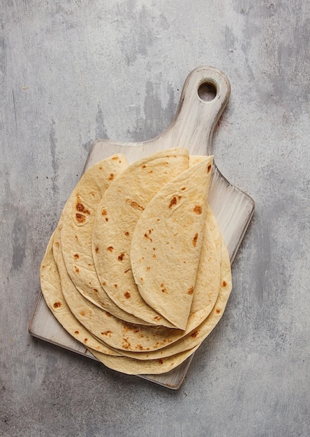 A stack of Mexican tortillas on a gray table top view closeup no people