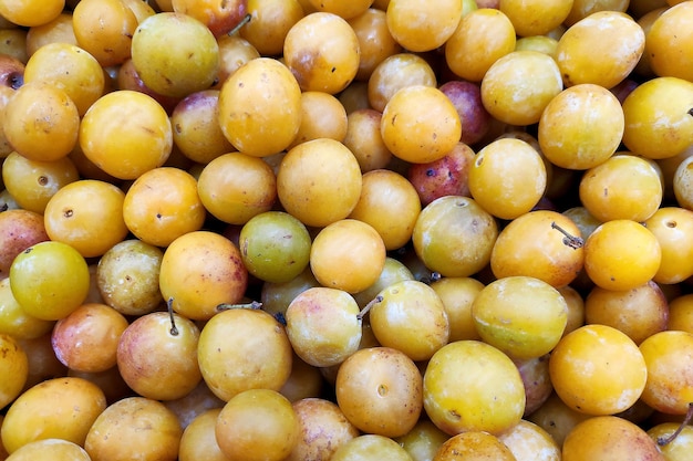 Stack of Mirabelle plums on a market stall