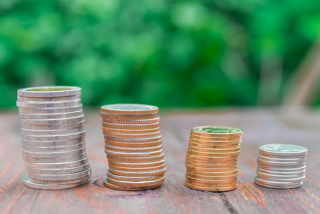 Stack money coin growing graph on wood backgroundbright sunlight