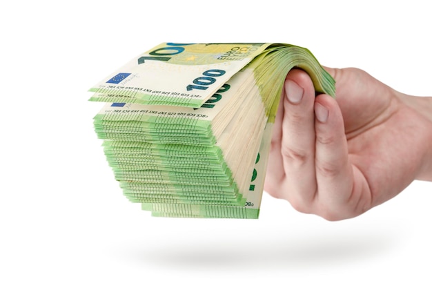 Stack of money in hand isolated on white background 100 euro banknotes in a man's hand A man holds out his hand with a stack of banknotes as a concept for a loan insurance or mortgage