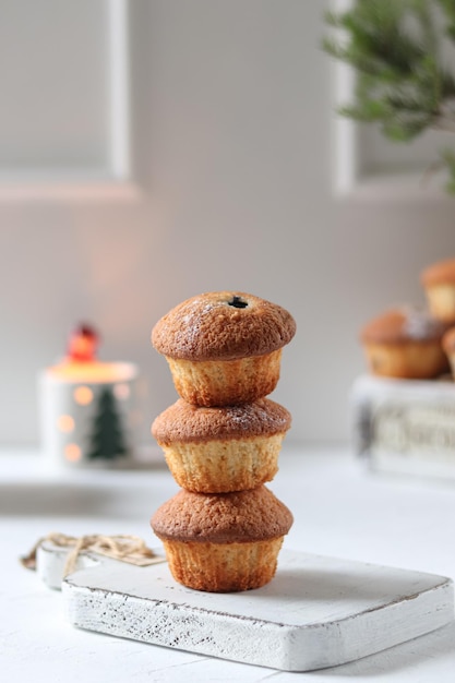 A stack of muffins with a sign that says " happy holidays " on the top.