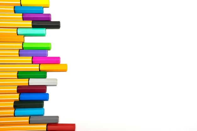 Stack of multi colored pencils against white background