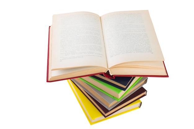 Stack of multicolored books One open on white isolated background