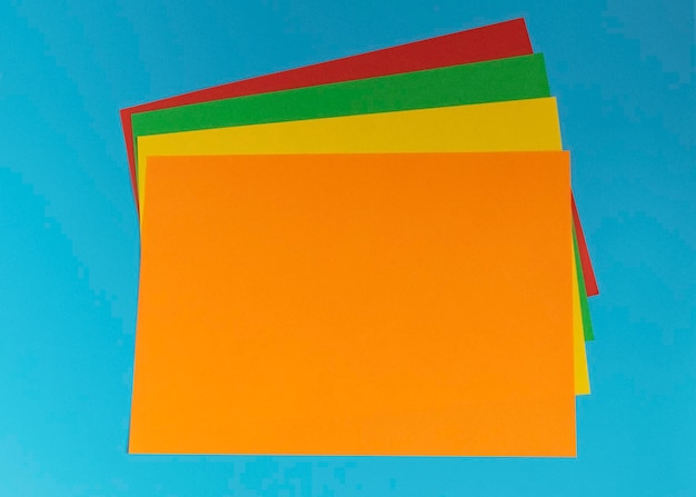 Stack of multicolored paper on a blue background