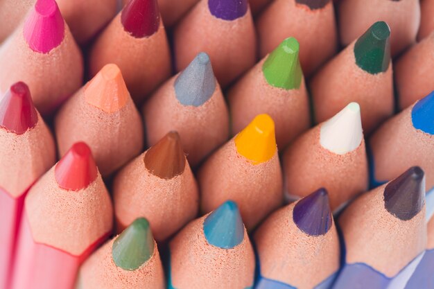 Photo stack of multicolored pensils tops details