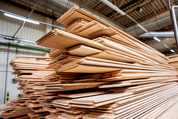 Stack of natural rough wooden boards. Wooden boards, lumber, industrial wood.