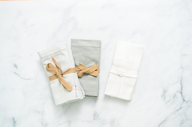 Stack of new linen dinner napkin on the kitchen counter.