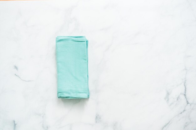 Stack of new linen dinner napkin on the kitchen counter.