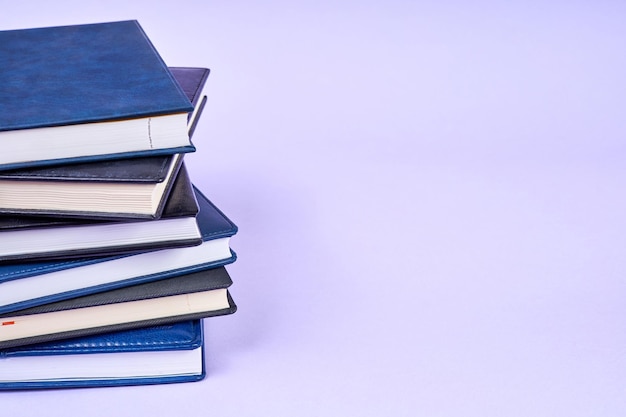 Stack of office notepads on purple background