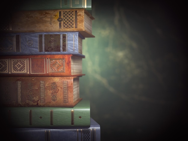 Stack of old books on green vintage background