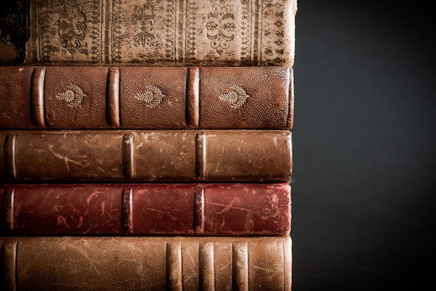 Stack of old books isolated on black background