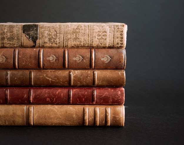 Stack of old books isolated on black background