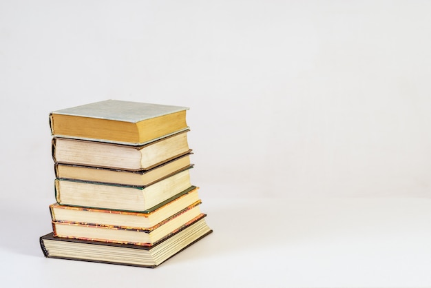 Stack of old books on white background