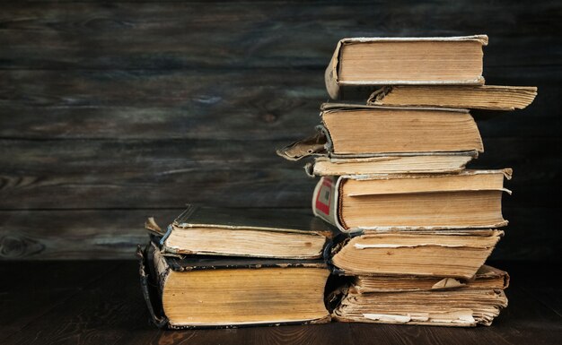 A stack of old books on a wooden background. Vintage books.