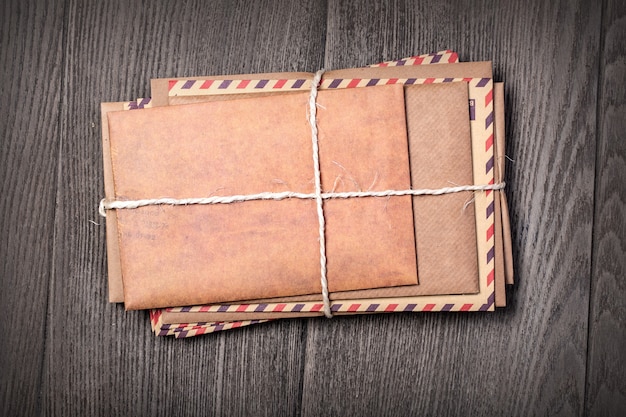 Stack of old envelopes on wooden table