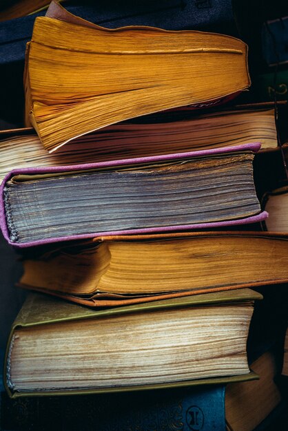 A stack of old paper books. Faded paper pages.