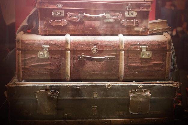 Stack of old suitcases behind glass