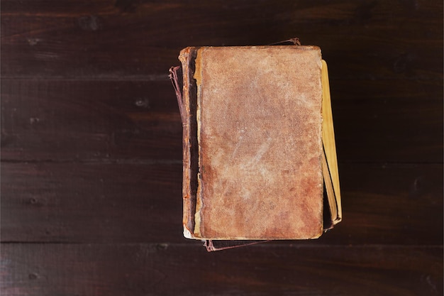 Stack of old vintage books on brown wood background theme of the reading and education selective f