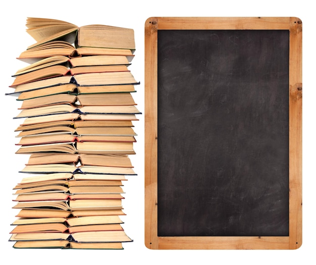 Stack of open books with school blackboard