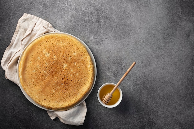 stack of pancakes on a plate with honey, maslenitsa