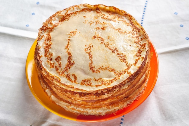 Stack of pancakes. Thin pancakes on a plate. Traditional food. Folk cuisine.