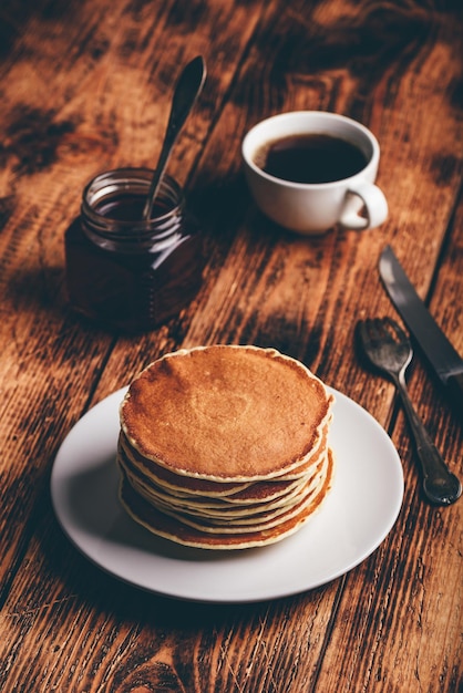 Stack of pancakes on white plate